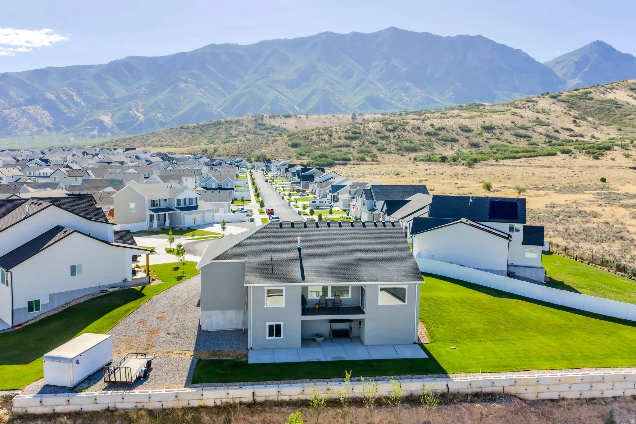 Modern two-story residence with a gray exterior and dark shingle roof