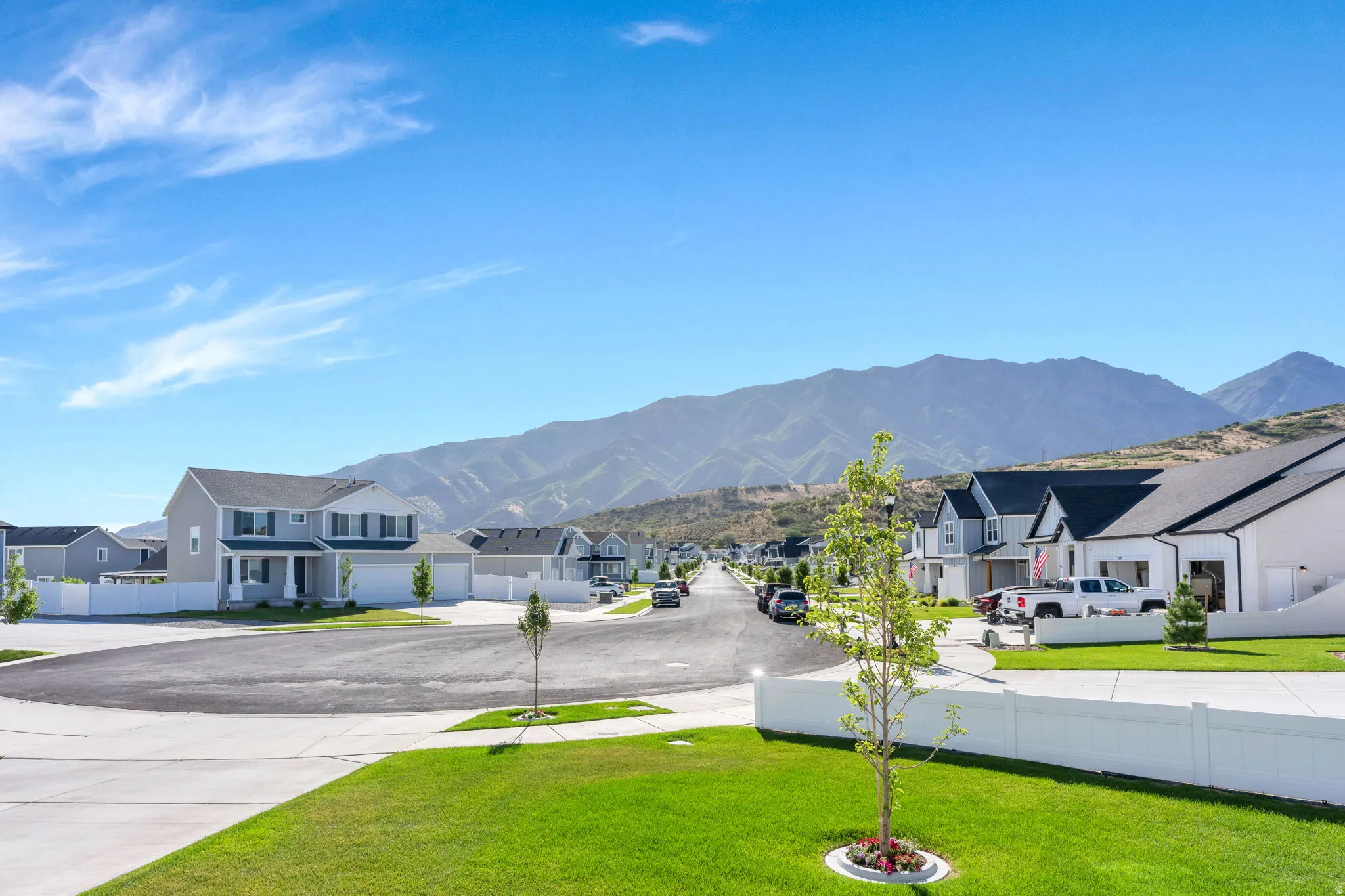 View from Front Door=Newly constructed residential street with contemporary homes, featuring mountain scenery, paved roads, and manicured lawns