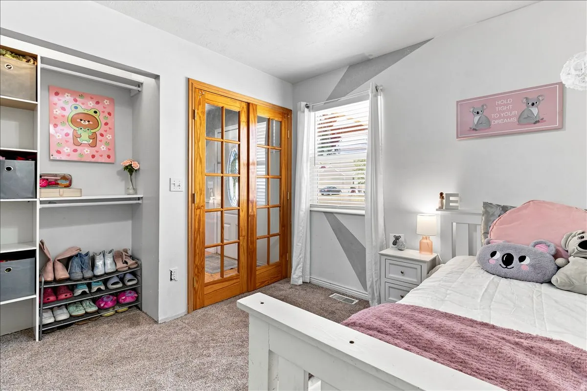Interior space featuring a built-in closet system with shelving and hanging rods