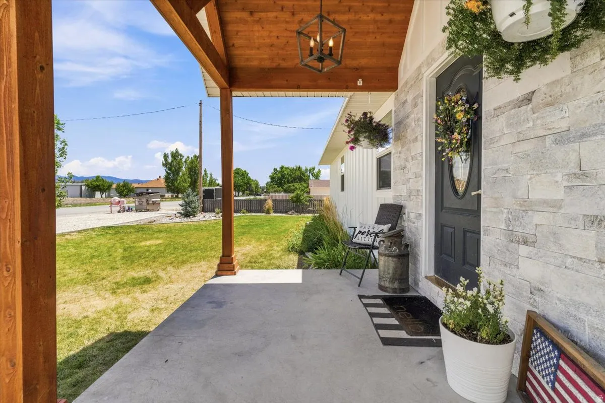 Covered front porch featuring a wood-finish ceiling with a dark metal lantern-style light fixture