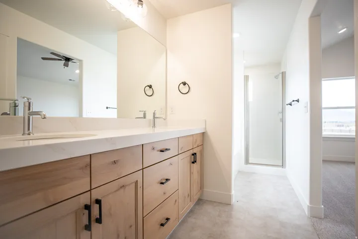 Primary bathroom featuring dual vanity and separate tub and shower