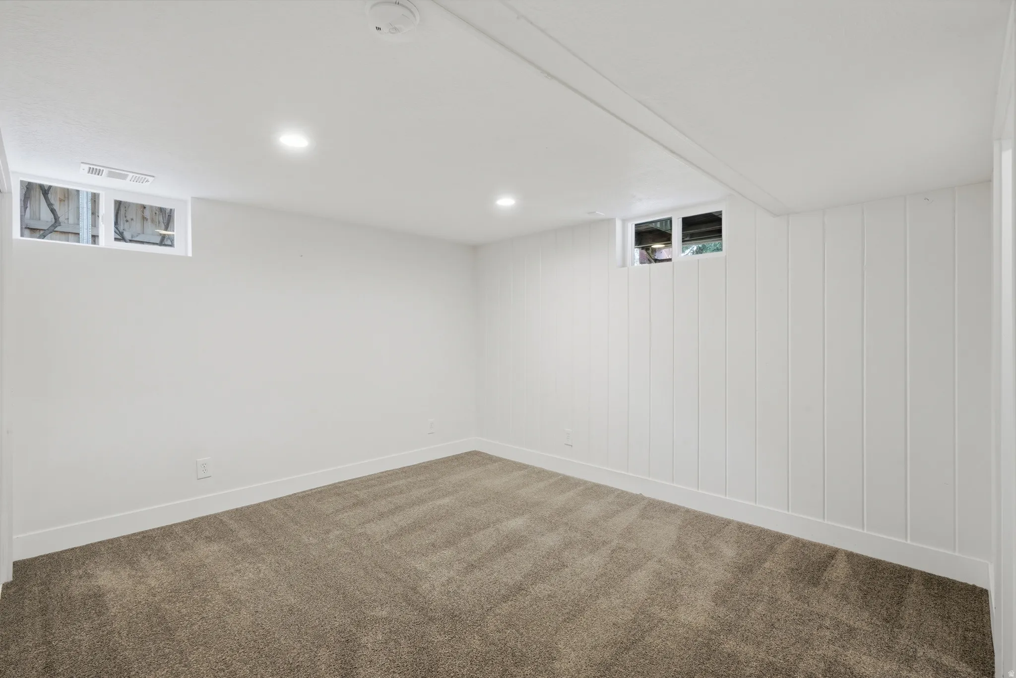 Bright interior space featuring recessed lighting and plush carpeting