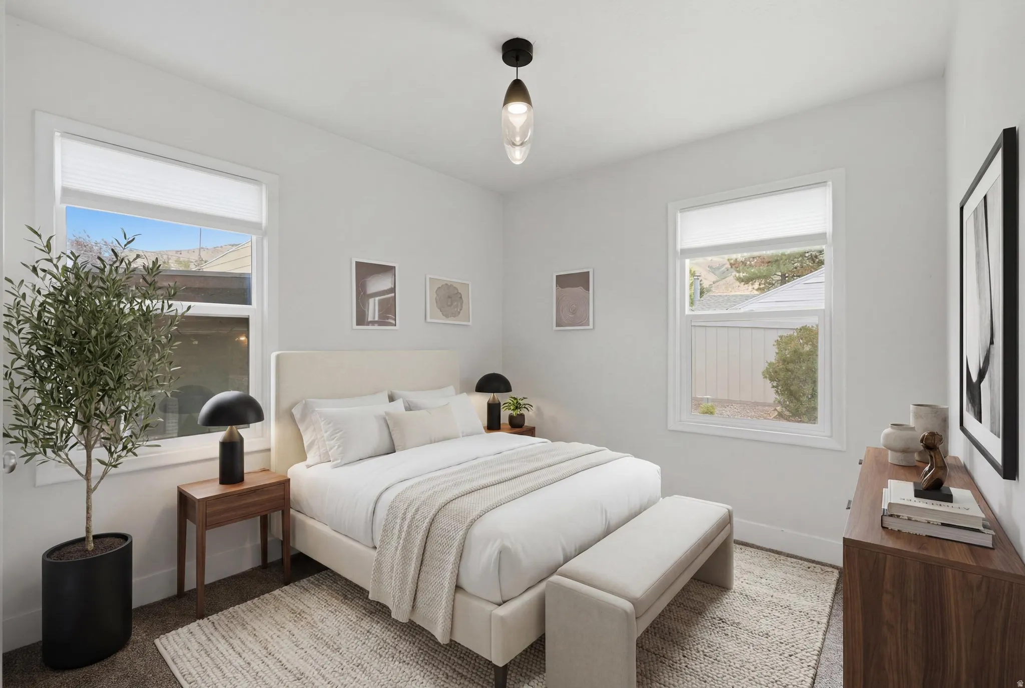 Virtually staged. Bright interior space featuring two windows with white trim, a ceiling-mounted light fixture, and neutral wall paint