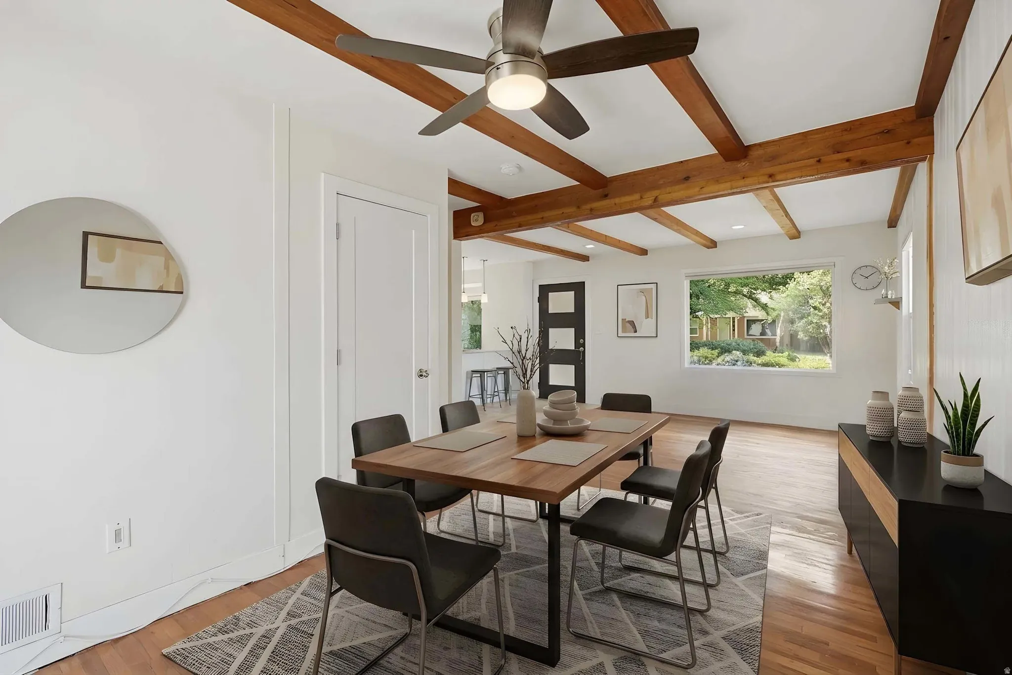 Virtually staged. Dining area featuring exposed wood ceiling beams and a contemporary ceiling fan