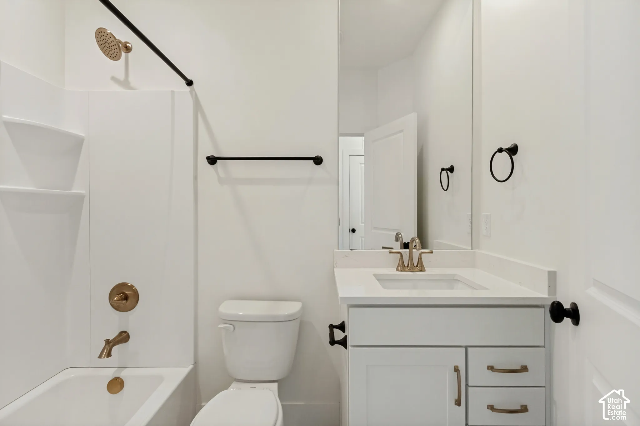 White vanity with a neutral countertop and integrated sink