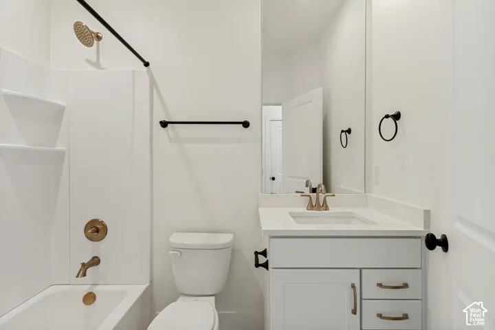 White vanity with a neutral countertop and integrated sink