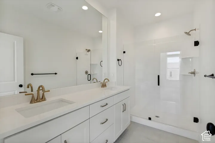 Dual vanity with integrated sinks, brushed gold-tone faucets, and a white countertop