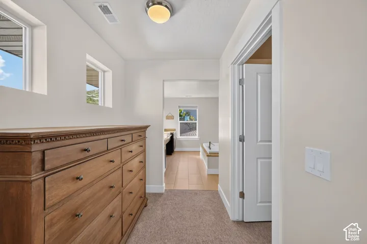 Hallway with neutral wall paint, recessed lighting, and carpeted flooring