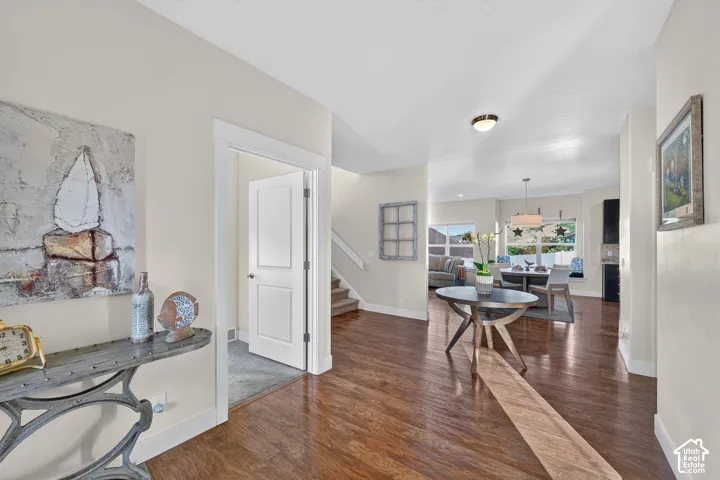 Open-concept interior featuring wood-finish flooring, neutral wall tones, and recessed lighting
