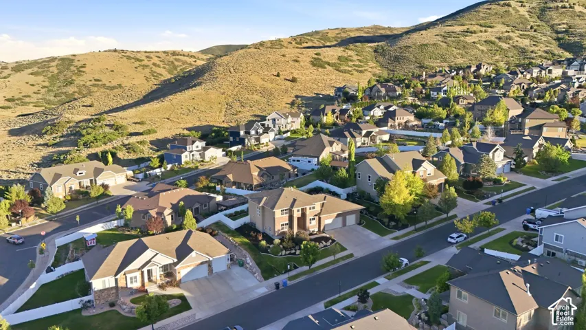 Residential neighborhood featuring single-family homes with pitched roofs, attached garages, and landscaped yards
