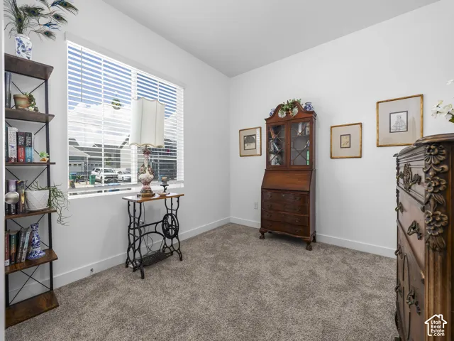 Bright room with neutral carpeting and white baseboards