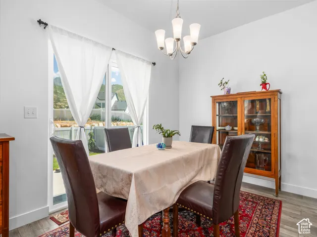 Dining area with neutral wall finishes and wood-finish flooring