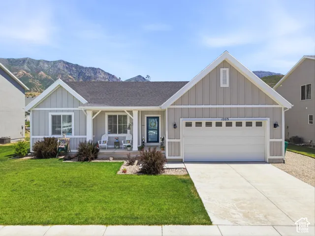 Single-story residence featuring light gray vertical siding with white trim