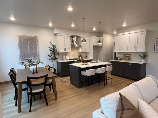 Open-concept kitchen and dining area with light wood-finish flooring