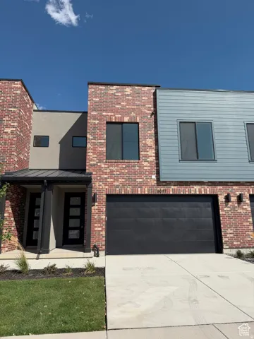 Contemporary multi-level facade featuring brick and siding accents