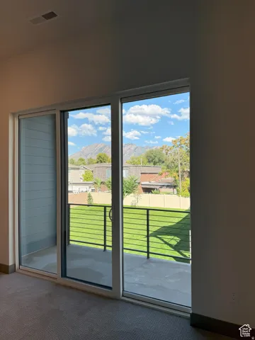 Sliding glass door leading to an outdoor patio with cable railing