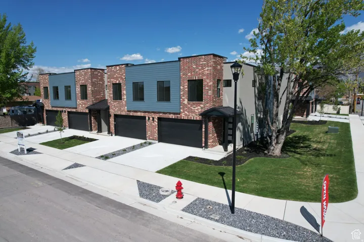 Contemporary townhome exteriors featuring brick and horizontal siding accents