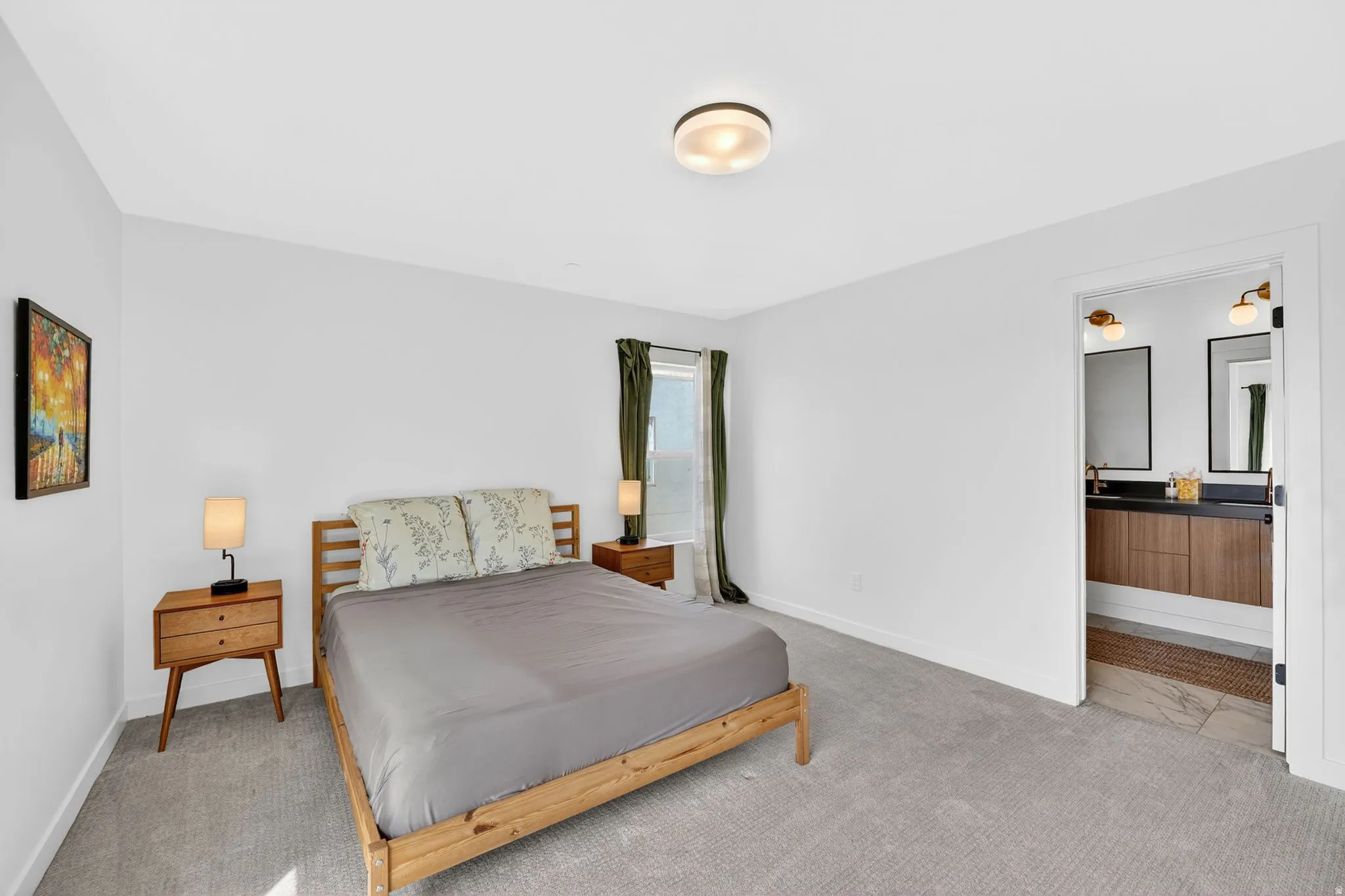 Bright room featuring light grey carpeting and a ceiling-mounted light fixture