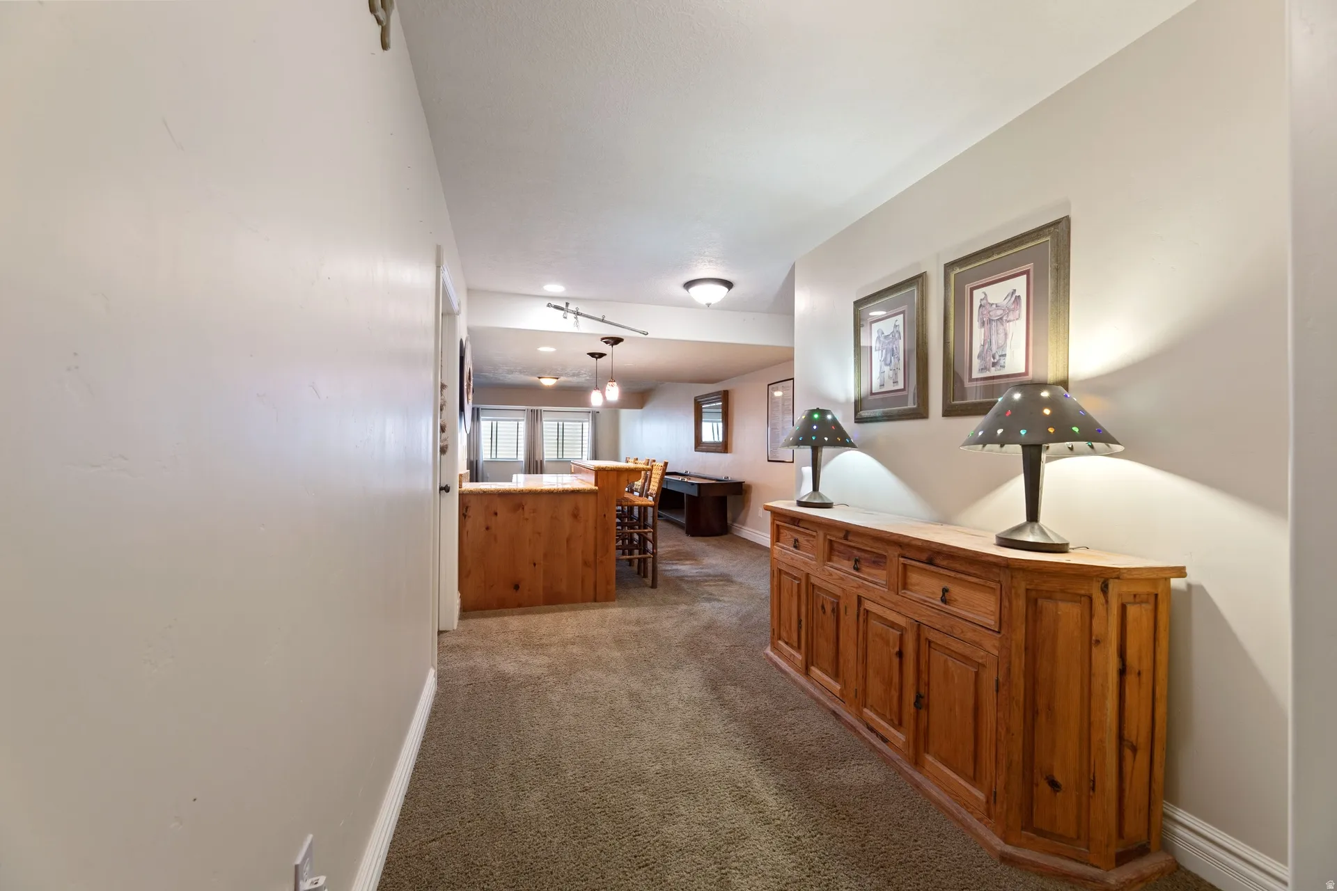 Spacious interior hallway featuring neutral wall tones and carpeted flooring