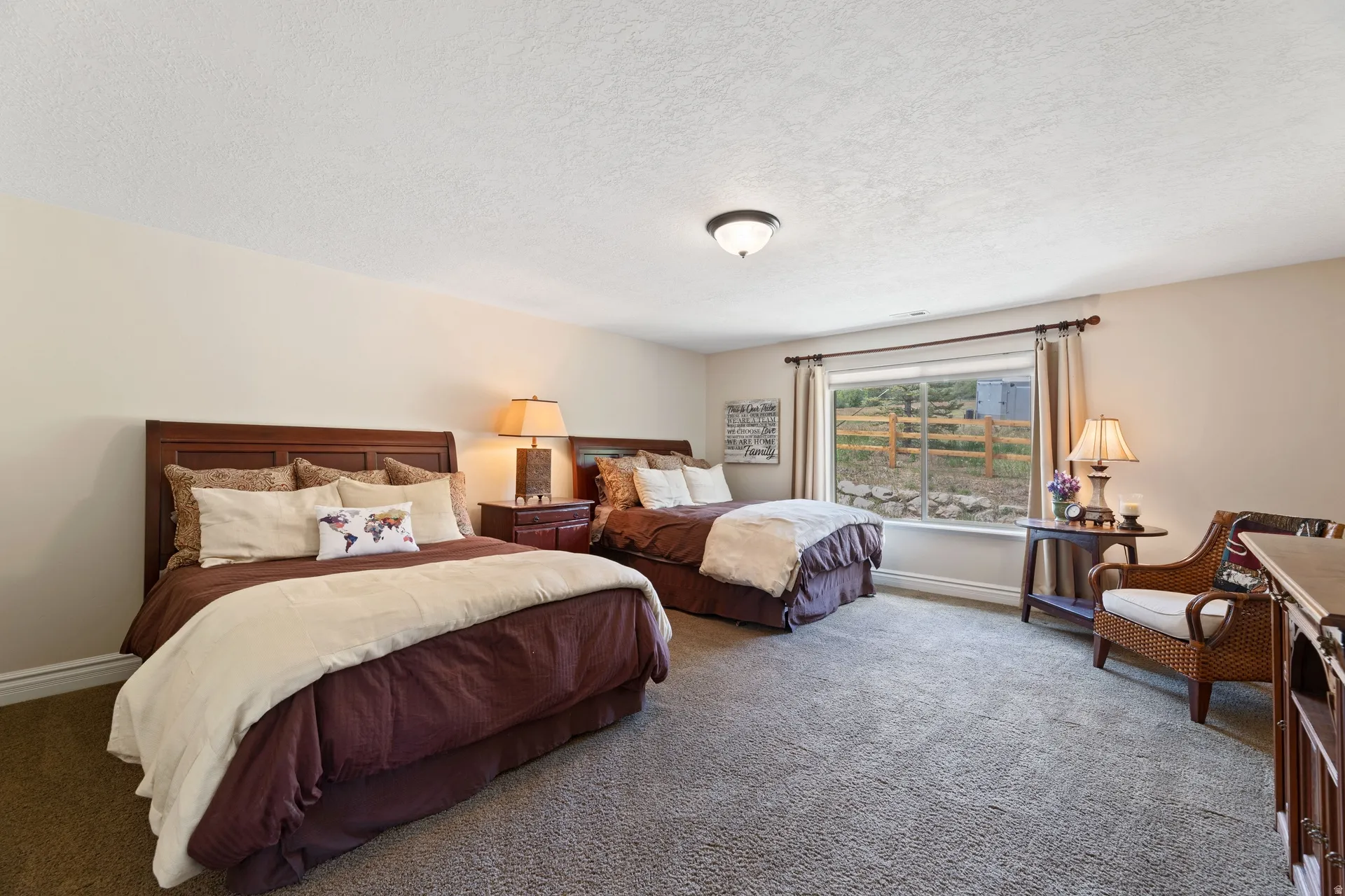 Spacious guest bedroom, a large window sporting beautiful unobstructed mountain views, neutral carpeting, and light-toned walls, with huge walk-in closet;