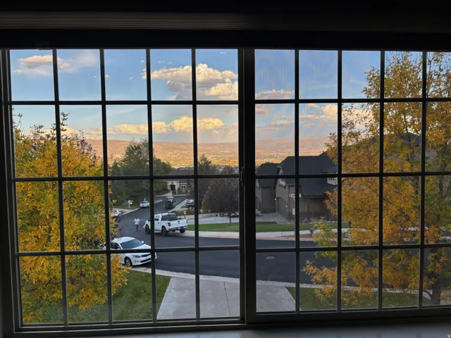 Large grid-pattern window offering expansive sky and distant landscape view of Midway-Heber Valley