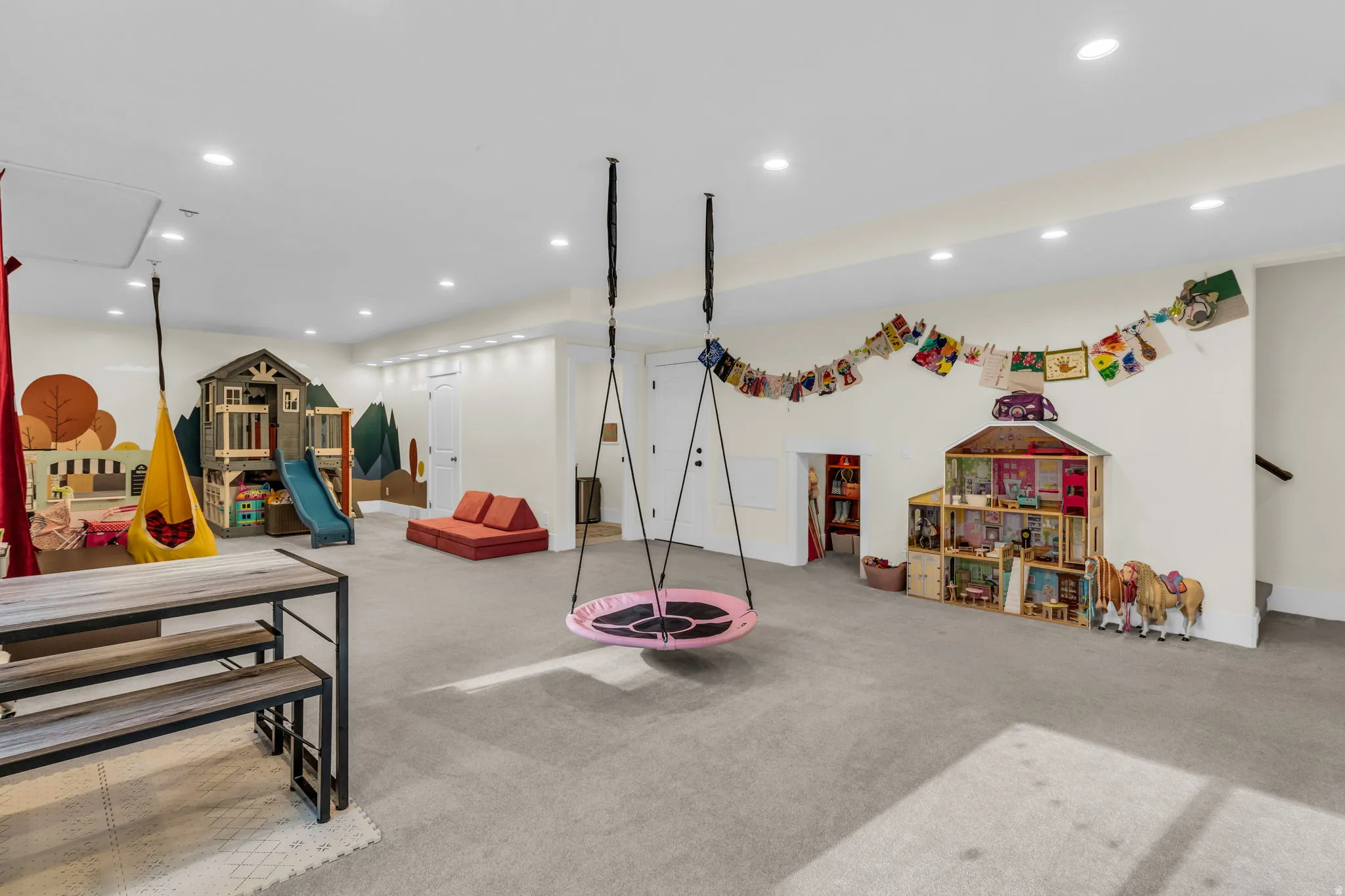 Spacious room featuring light gray carpet flooring and recessed ceiling lights