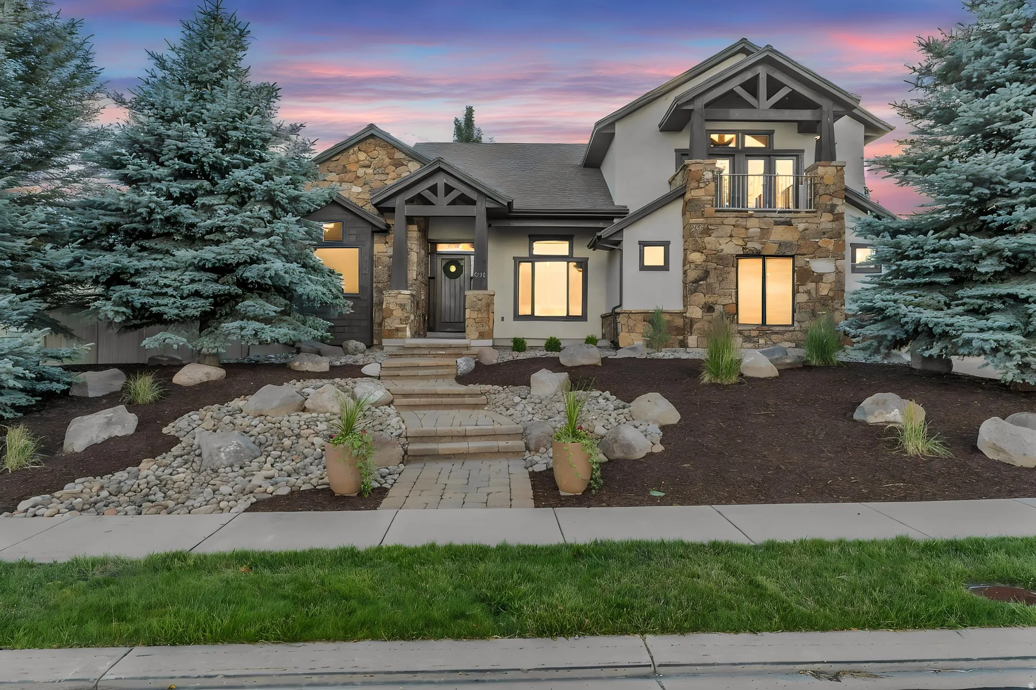 Multi-textured facade featuring stone, stucco, and dark wood accents