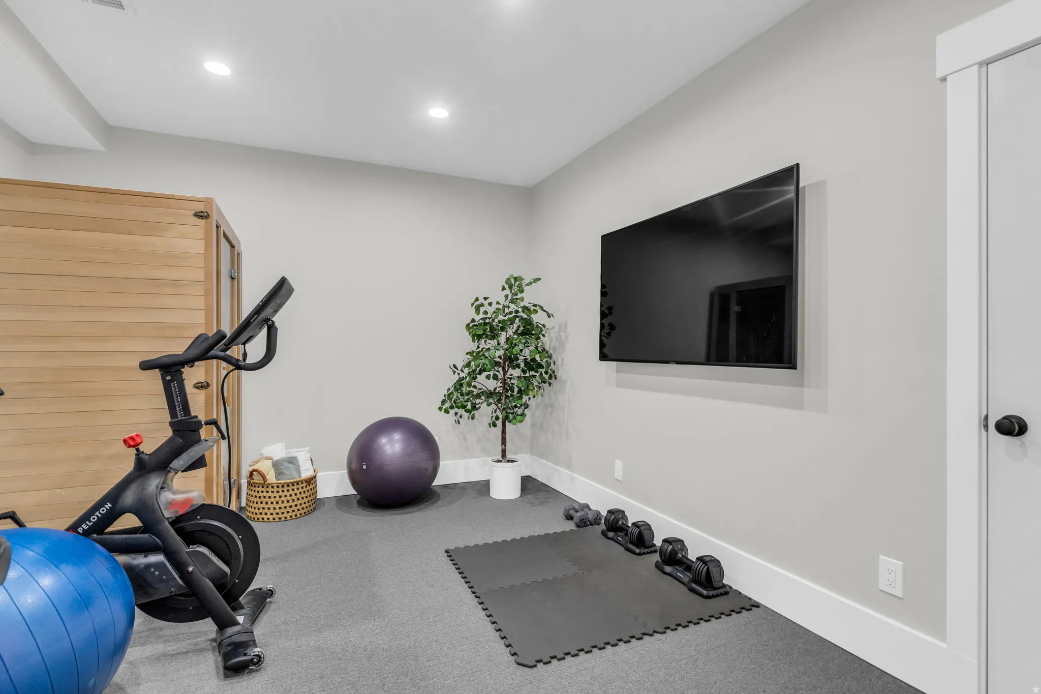 Dedicated fitness space featuring recessed lighting and gray carpeting.  Recently added.