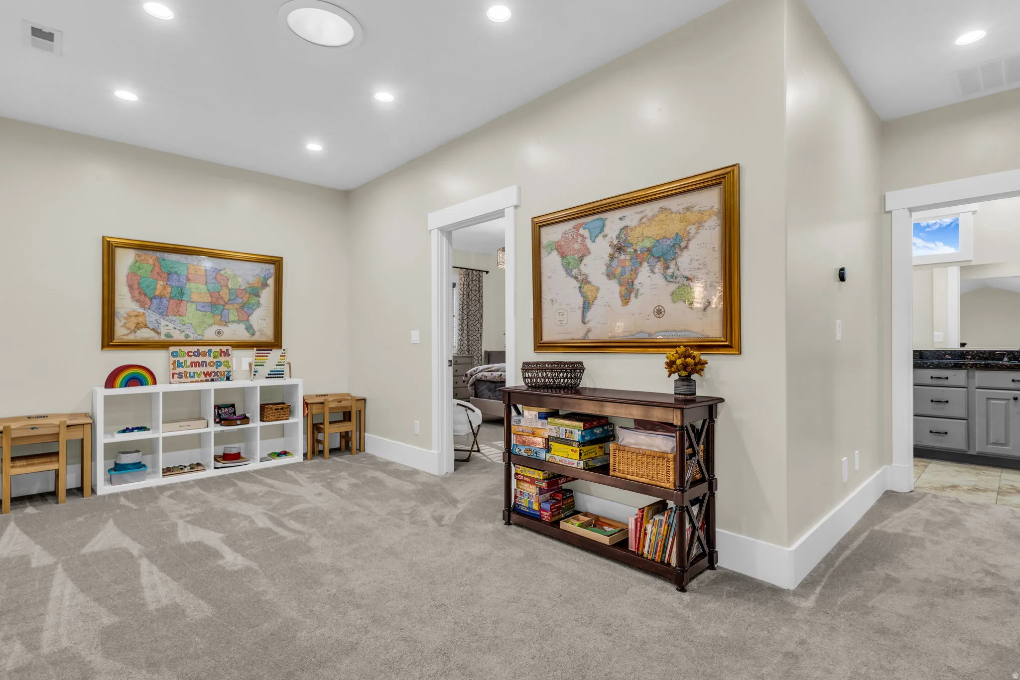 Spacious carpeted room featuring recessed lighting, a built-in shelving unit, and white trim molding