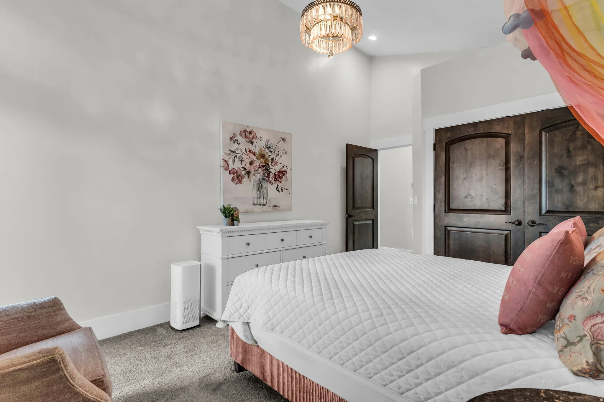 Bedroom featuring high ceilings and dark wood-finish doors