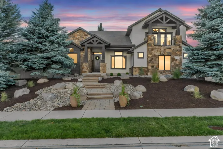 Multi-textured facade featuring stone, stucco, and dark wood accents