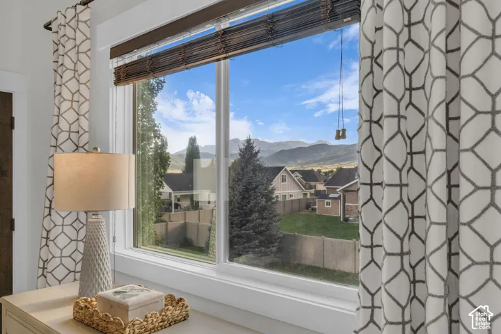 Large window framing a Timpanogos view featuring white trim and a dark wood blind
