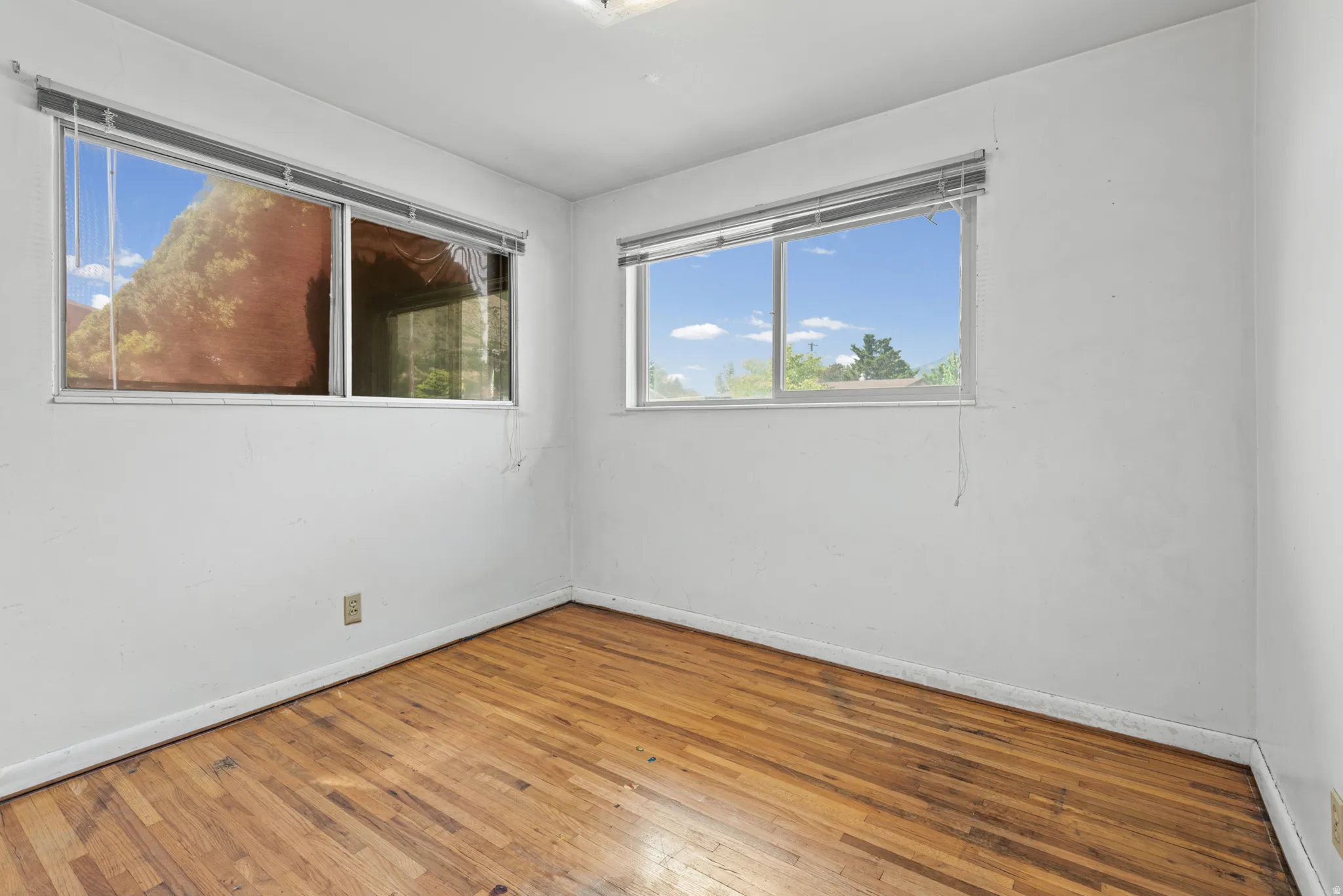 Wood-finish flooring throughout, complemented by white walls and trim