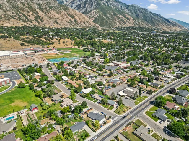 Expansive aerial showcasing a residential neighborhood with mountain backdrop