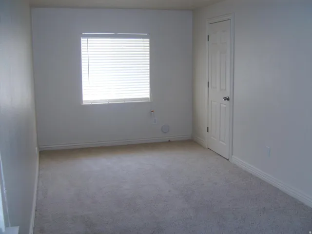 Neutral-toned carpeting paired with light-colored walls and white trim
