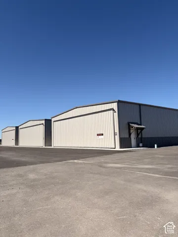 Commercial building with corrugated metal siding and a dark trim