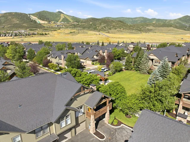 Residential community featuring multi-level dwellings with stone accents and dark shingle roofing