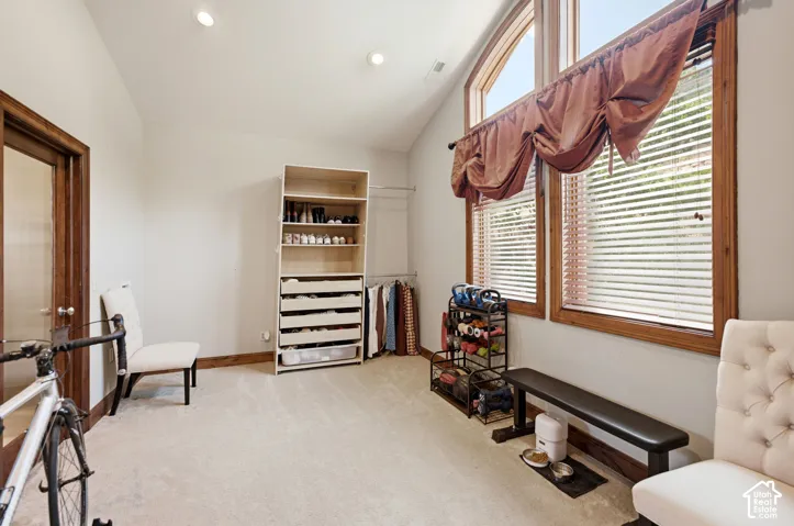 Room featuring vaulted ceilings and recessed lighting