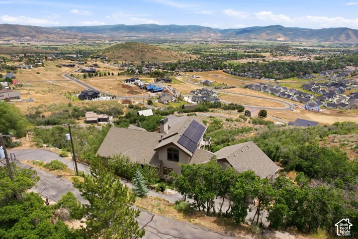 Expansive residential property featuring a multi-level structure with a gabled roof and integrated solar panels