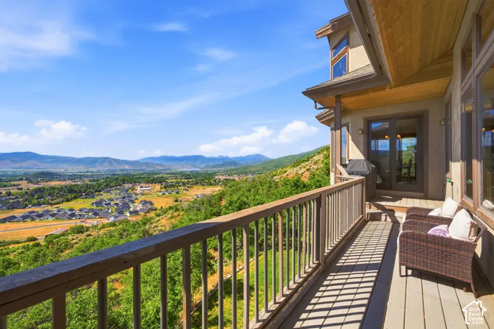 Expansive outdoor deck featuring wood-finish decking and railing