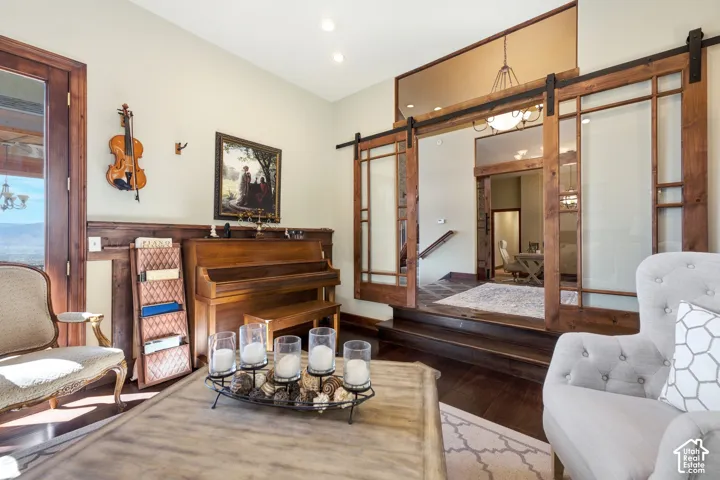 Spacious room with dark wood-finish flooring, light-toned walls, and recessed lighting