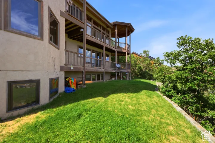 Multi-level exterior with stucco finish and wood-framed windows