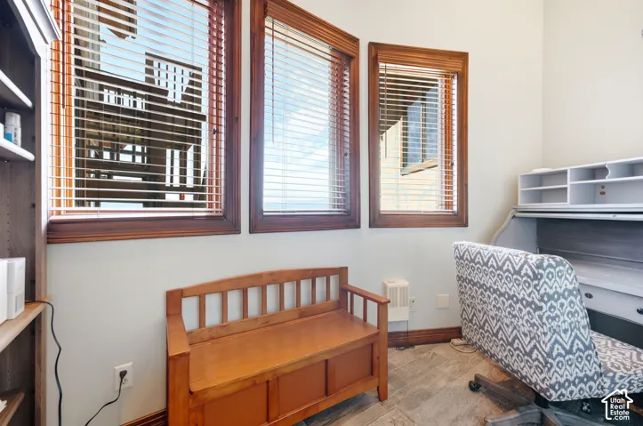 Three windows with wood trim and horizontal blinds