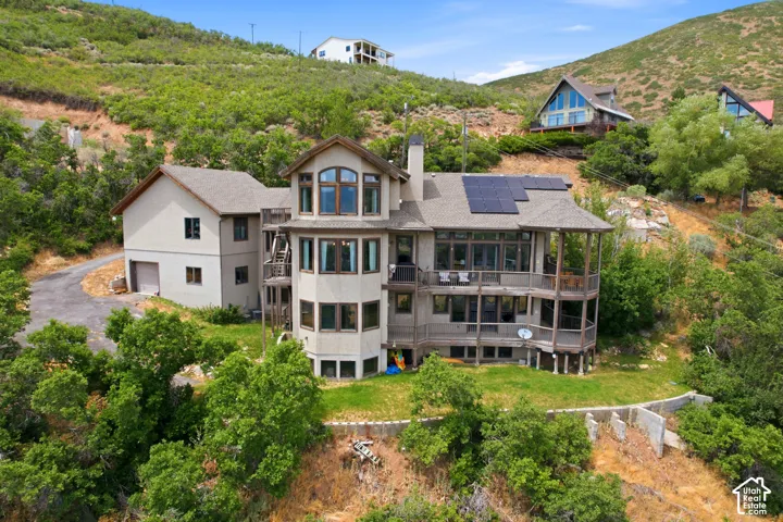Multi-level residence featuring extensive rear decking and solar panel installation