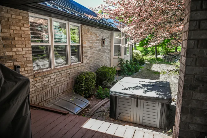 Exterior brick siding with white window frames and a dark metal roof