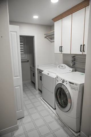 Laundry area featuring tile flooring, built-in cabinetry, and recessed lighting