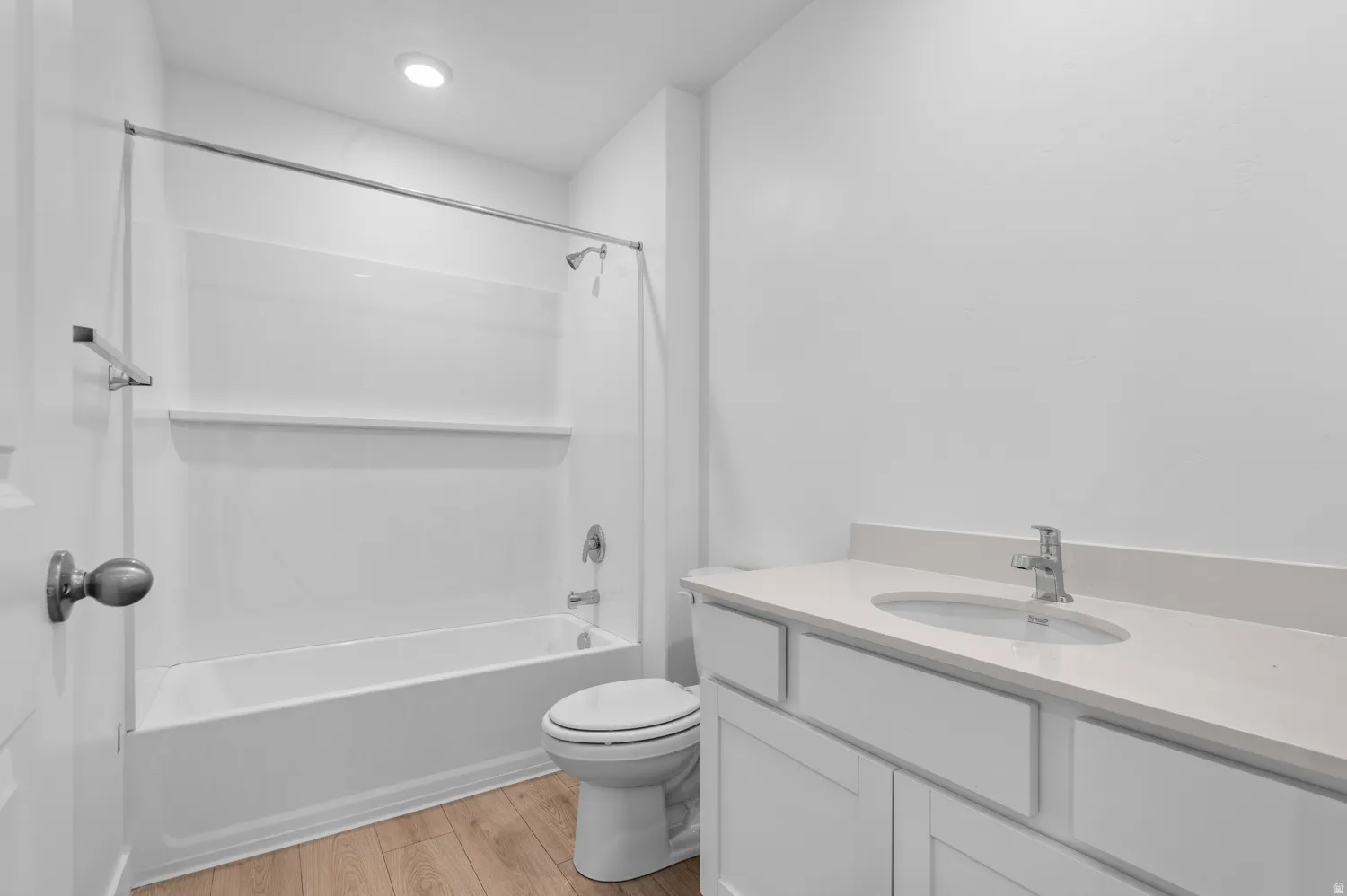 Bathroom with a white vanity featuring an integrated sink and light-toned countertop