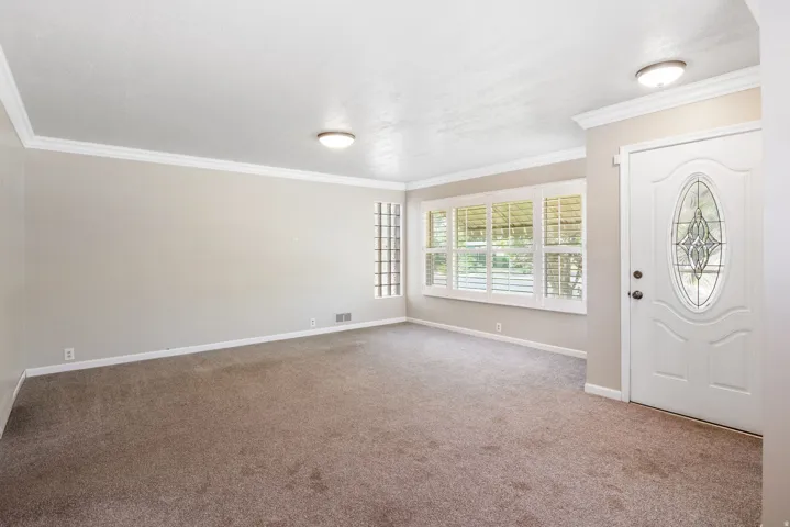 Entry space with light-toned walls and carpet flooring