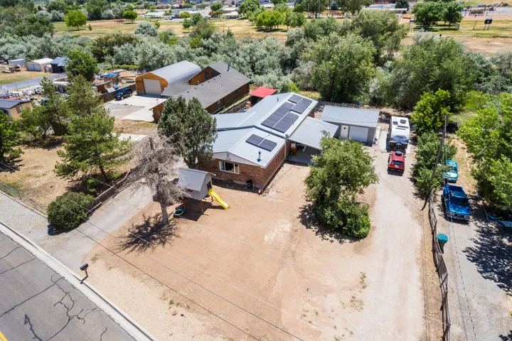 Property featuring a brick exterior and a metal roof with integrated solar panels