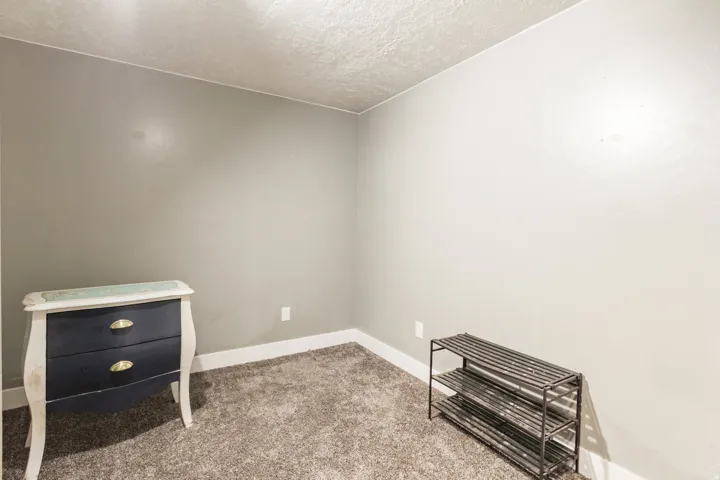 Wall-to-wall carpeting with light gray walls and white baseboards